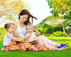Frau mit Tochter und Sohn lesen Märchen foto
