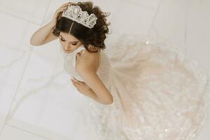 oben Sicht, schön Braut, mit ein Weiß Hochzeit Kleid und ein luxuriös Krone auf ihr Kopf. horizontal Foto
