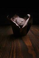 Schokolade Cupcake auf ein dunkel Hintergrund. Muffin mit Schokolade Chips auf ein hölzern Oberfläche. foto