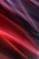 abstrakt Vertikale rot Hintergrund mit diagonal glatt Linien Wellen. Licht und Strahlen sind verschwommen im Bewegung. foto