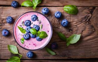 ai generiert Blaubeere Smoothie mit Blaubeeren und Basilikum Blätter auf hölzern Tabelle foto