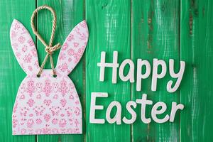 ai generiert glücklich Ostern Gruß Karte mit Weiß Hase Ohren und Eier auf Grün Hintergrund foto