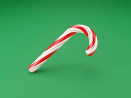 Frohe Weihnachten Stöcke, Lollipop Minzbonbons mit roten Streifen auf grünem Hintergrund. Neujahrsfeier Konzept. traditionelles süßes Dessert. 3D-Rendering foto