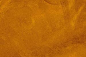 Licht Orange Samt Stoff Textur benutzt wie Hintergrund. Seide Farbe Safran Stoff Hintergrund von Sanft und glatt Textil- Material. zerquetscht Samt .Luxus Sonne Licht Ton zum Seide. foto