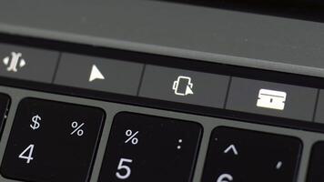 schließen oben von berühren Pad von ein Tastatur mit nur etwas von das Schlüssel im Fokus. Aktion. Symbole auf ein berühren Pad von ein Computer, Konzept von modern Technologien. foto