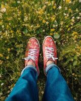 ai generativ Nahansicht von ein Paar von Schuhe auf ein Wiese von Gänseblümchen tätowieren auf das Bein tätowieren Natur und Menschen Konzept foto