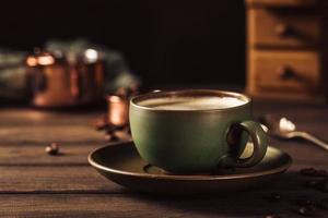 grüne Tasse Kaffee mit Kaffeemühle foto