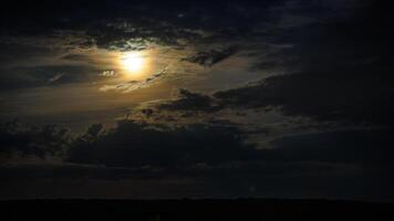 Mond zwischen Nacht Wolken über Horizont foto