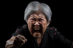 ai generiert wütend Senior asiatisch Frau Geschrei und schwingen Faust auf schwarz Hintergrund. neural Netzwerk generiert fotorealistisch Bild. foto