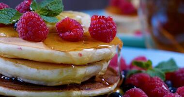 köstlich Frühstück. Pfannkuchen mit Himbeere, Banane und ein Minze Blatt und Honig foto