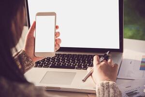 Geschäftsmann Arbeiten auf Clever Telefon und Laptop im öffnen Raum Büro. Treffen Bericht im Fortschritt. foto