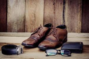 Reise Zubehör, Schuhe, Gürtel, Brille, Geldbörse, bereit zum das Ausflug auf Holz foto