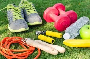 Fitness Konzept mit Übung Ausrüstung auf Grün Gras Hintergrund. foto