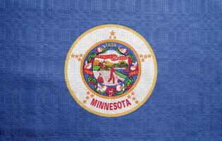 Flagge von Minnesota Zustand USA auf ein texturiert Hintergrund. Konzept Collage. foto