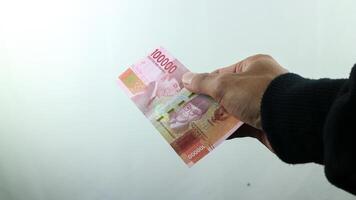 Hand halt Geld Rupiah, Transaktion Konzept, finanziell Konzept foto