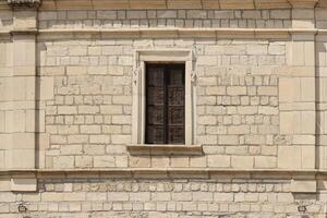 sehr alt Fenster im Backstein Stein Mauer von Schloss oder Festung von 18 .. Jahrhundert. voll Rahmen Mauer mit Fenster foto