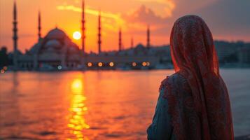 ai generiert beim Sonnenuntergang im Istanbul, ein Frau im ein Kopftuch ist Aufpassen das Moschee Landschaft foto