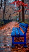 ai generiert beschwingt Blau Park Bank auf ein nass Herbst Tag umgeben durch gefallen Blätter foto