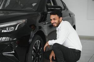 glücklich indisch Mann Kaufen Neu Biodiesel Öko Automobil im Lux Ausstellungsraum. foto