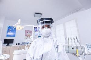 geduldig pov von Zahnarzt im schützend Ausrüstung gegen Infektion mit covid Virus im Dental Büro. stomatologe tragen Sicherheit Ausrüstung gegen Coronavirus während Wärmepflege prüfen von geduldig. foto