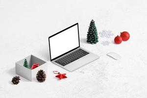 Online-Shopping für Weihnachtsgeschenke-Konzept. Laptopmodell, Geschenkbox und Dekorationen daneben. foto