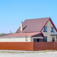 Haus mit Plastik Fenster und Dach von gewellt Blatt. Überdachung von Metall Profil wellig gestalten auf das Haus mit Plastik Fenster foto