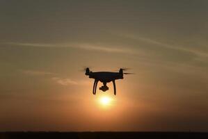 Drohne Silhouette gegen das Hintergrund von das Sonnenuntergang foto