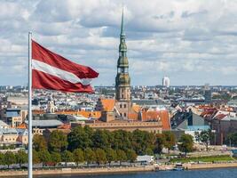 Panorama von riga Stadt mit ein groß lettisch Flagge im Vordergrund foto