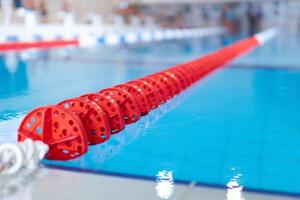 Fragment von das Wettbewerb Schwimmbad mit Blau Wasser und markiert Schwimmen Fahrspuren foto