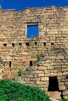 Ruinen von Stein Mauer gegen das Himmel im das uralt verlassen Dorf von gamsutl foto