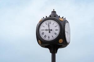 Öffentlichkeit Uhr zum Stadt Platz unter das öffnen Himmel foto