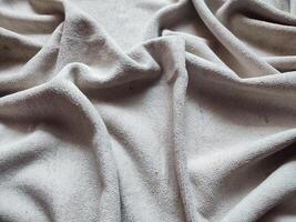 Textur, Muster, Hintergrund von schmutzig Weiß Handtuch ausgesetzt zu Sonnenlicht foto