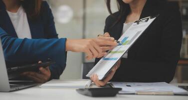 asiatischer geschäftsmann und geschäftsfrau des unternehmers, die neues geschäftsprojekt in tablette in modernem treffen im modernen büro, asiatisches geschäfts-beiläufiges konzept besprechen. foto