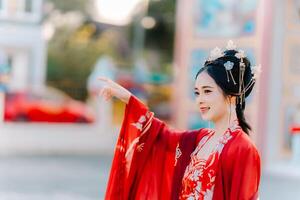 Frau Kleid China Neu Jahr. Porträt von ein Frau. Person im traditionell Kostüm. Frau im traditionell Kostüm. schön jung Frau im ein hell rot Kleid und ein Krone von Chinesisch Königin posieren. foto