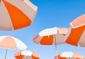 Cluster von Orange und Weiß Strand Regenschirme gegen klar Himmel foto