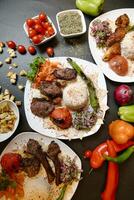 Tabelle geschmückt mit Platten von Essen bedeckt im verschiedene Typen von Fleisch. foto