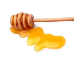 Honig Schöpflöffel auf Weiß Hintergründe foto