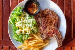 gegrillt Schweinefleisch Rippen Steak gut gemacht mit Französisch Fritten und Gemüse foto