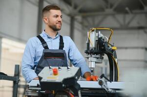 männlich Fabrik Mechanik oder Ingenieur im Sicherheit Uniformen sind Arbeiten auf Metall Bohren Maschinen im industriell Produktion Linien, Stahl wird bearbeitet Industrie, mechanisch Wartung. foto