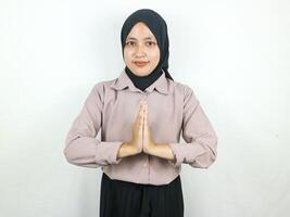lächelnd asiatisch Muslim Frau tragen Hijab Stehen und Gruß, suchen Kamera. eid Mubarak Konzept. foto