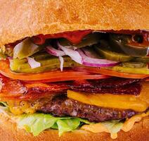 Burger mit Rindfleisch, Tomate, Käse, Speck und Grüner Salat Makro foto