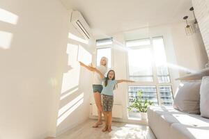 Mutter und Tochter hängen zu Hause eine große Fotoleinwand auf foto