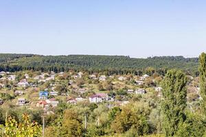 szenisch Aussicht von ein ländlich Landschaft mit üppig Grün und verstreut Häuser unter ein klar Blau Himmel im Moldau foto