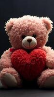 ai generiert herzlich kuscheln Teddy Bär hält rot Herz, perfekt Valentinsgrüße Symbol Vertikale Handy, Mobiltelefon Hintergrund foto