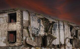 Ruinen von ein Gebäude gegen ein rot dunkel Himmel Hintergrund foto