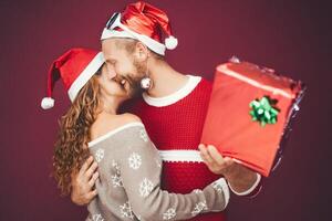 glücklich Paar feiern Weihnachten Zeit während Teilen die Geschenke - - jung Liebhaber haben Spaß während Weihnachten Ferien - - Jugend Lebensstil Kultur und Menschen traditionell Veranstaltung Konzept foto