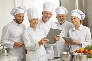 ai generiert modern Küche Mannschaft von Köche verwenden Tablette foto