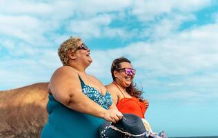 glücklich Plus Größe Frauen haben Spaß Gehen auf das Strand während Sommer- Urlaube - - Übergewicht Menschen Konzept foto