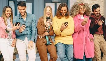 Gruppe von modisch freunde mit Handy, Mobiltelefon Smartphones draussen - - tausendjährig jung Menschen haben Spaß mit Neu Technologie Apps zum Sozial Medien - - Konzept von Jugend Kultur Generation z und Technologie foto