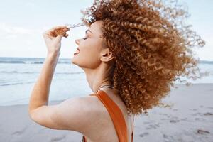 lockiges Haar Schönheit genießen Sonnenuntergang durch das Strand. glücklich Afroamerikaner weiblich mit zuversichtlich foto